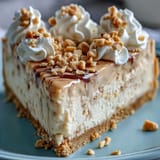 A close-up of Nutter Butter cheesecake reveals the textured peanut butter swirls in the creamy filling.