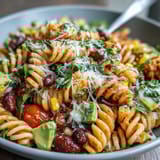 Easy Taco Pasta Salad for Summer Potlucks: Colorful pasta salad with black beans, corn, and creamy taco dressing, topped with crunchy tortilla chips.