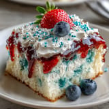 Festive red, white, and blue poke cake slices ready for holiday snacking.