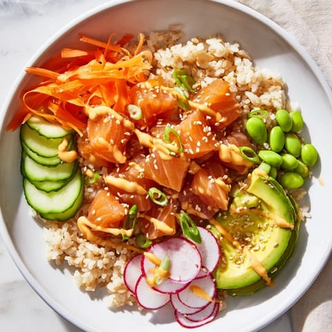 This beautiful poke bowl showcases fresh, diced fish atop fluffy rice and various toppings.