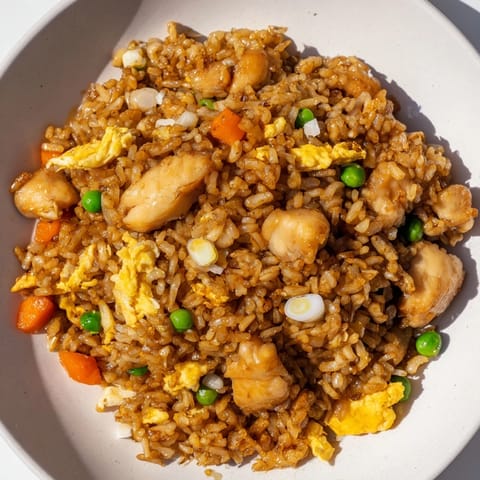 Golden, caramelized chicken chunks highlight this flavorful Chicken Fried Rice, perfect for dinner.
