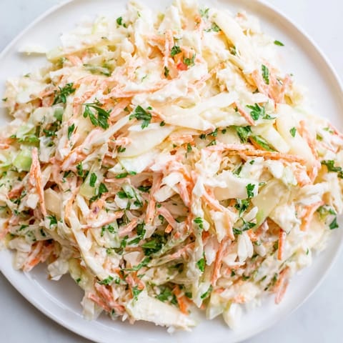 Creamy and crunchy Coleslaw with Apple, perfect served alongside grilled chicken or burgers.