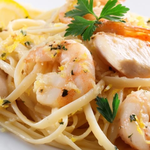 Hearty Lemon Garlic Shrimp & Chicken Pasta glistens with olive oil, fresh parsley, and a sprinkle of red pepper flakes.  