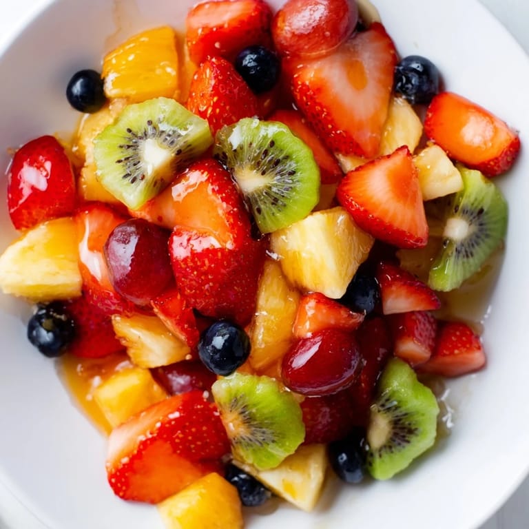 Enjoy this easy fruit salad with fresh orange and lemon syrup; ideal for a summer picnic.