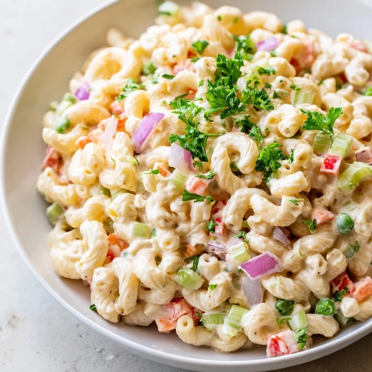 Cold and refreshing macaroni salad, a classic side dish featuring tender elbow pasta and tangy dressing.