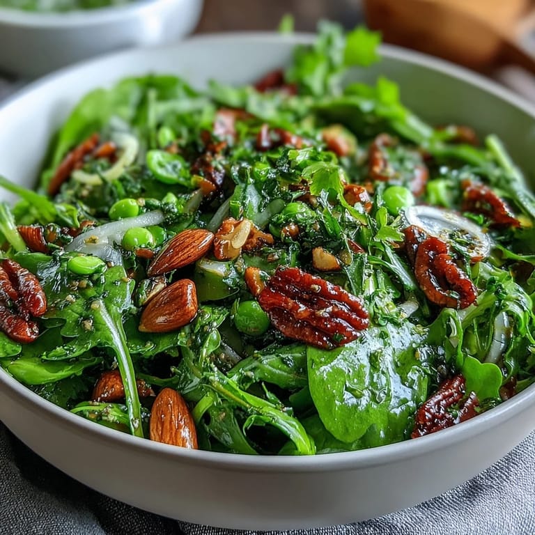 Bright and colorful spring green salad with honey mustard and almonds, featuring snap peas, radishes, and cucumber for a crisp, healthy bite.  
