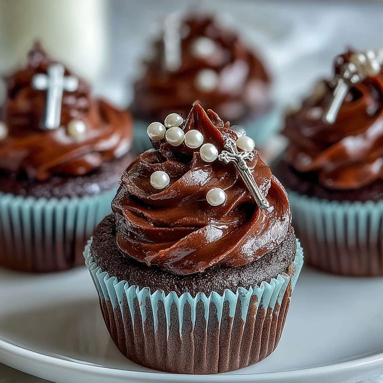 Sweet vanilla mini cupcakes with creamy frosting and edible fondant rosary decorations, ideal for religious milestone events.